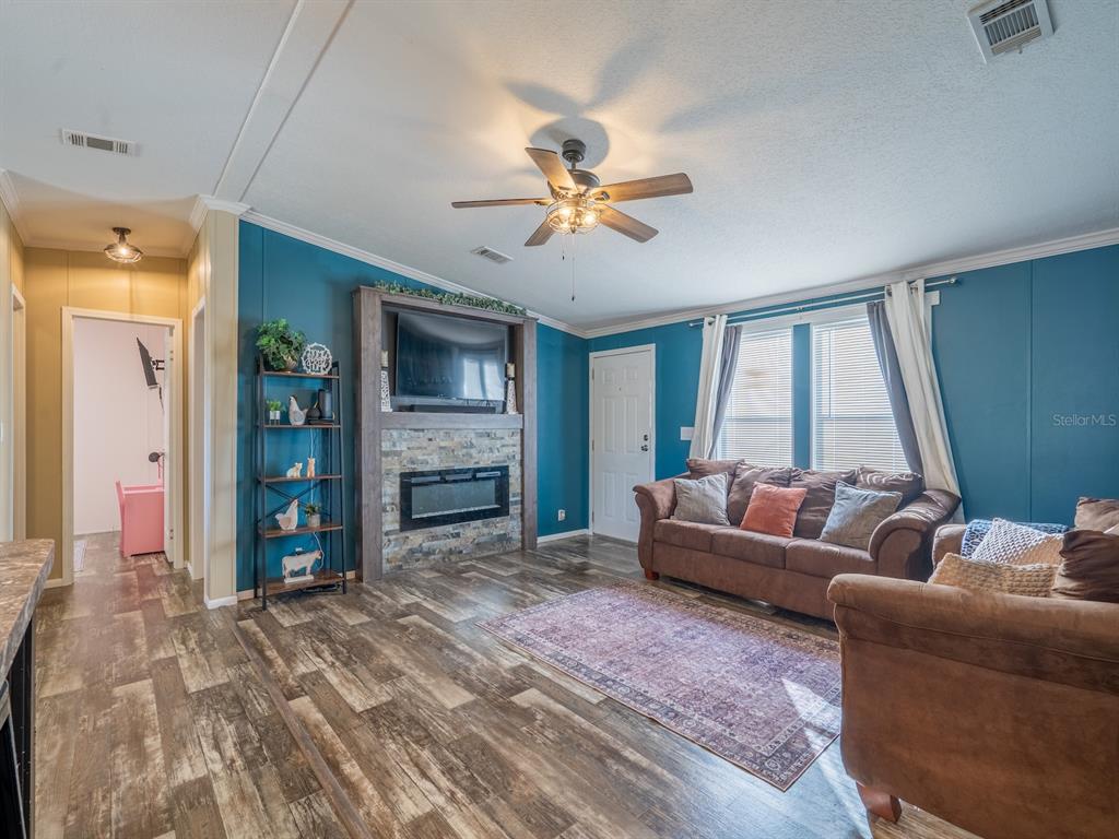22457 Northeast 130th Court Road Fort McCoy, FL 32134 - Photo 17 of 43 a living room with furniture and a fireplace