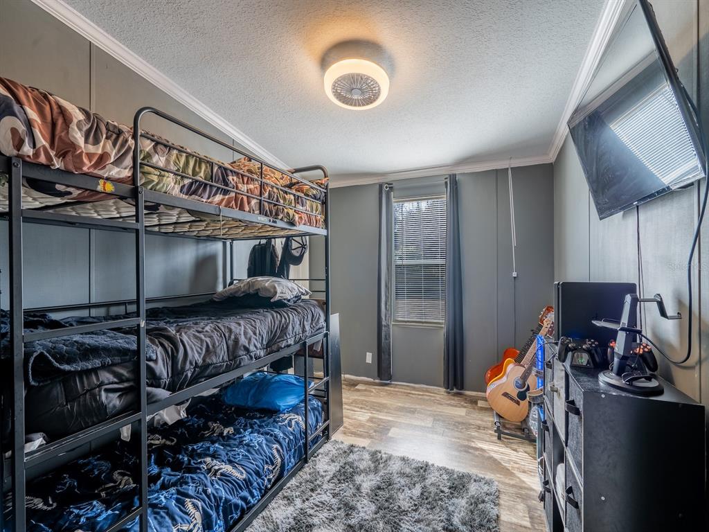 22457 Northeast 130th Court Road Fort McCoy, FL 32134 - Photo 23 of 43 a bedroom with a bed and a mirror