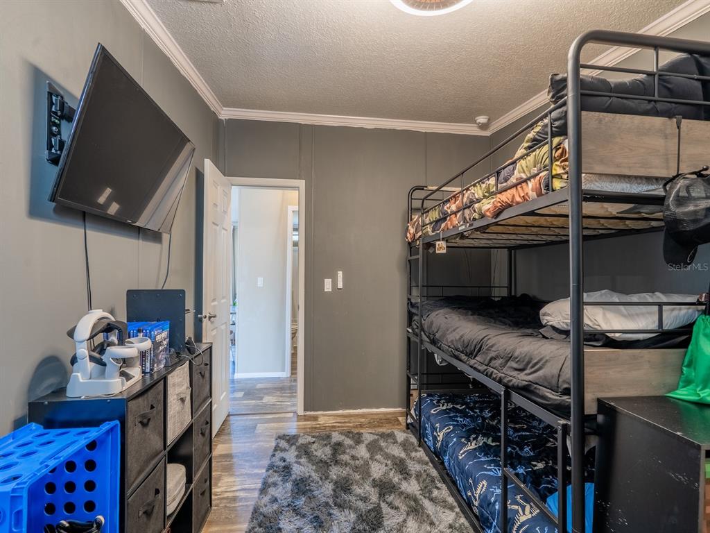 22457 Northeast 130th Court Road Fort McCoy, FL 32134 - Photo 24 of 43 a bedroom with a bed and a tv in it