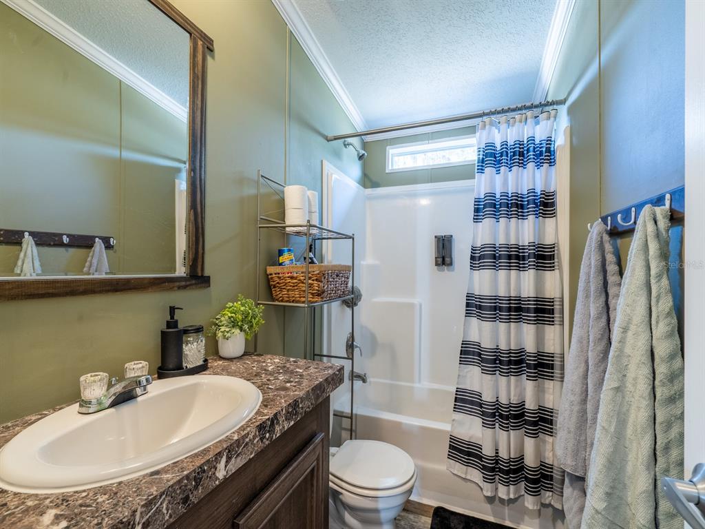 22457 Northeast 130th Court Road Fort McCoy, FL 32134 - Photo 25 of 43 a bathroom with a sink toilet and shower