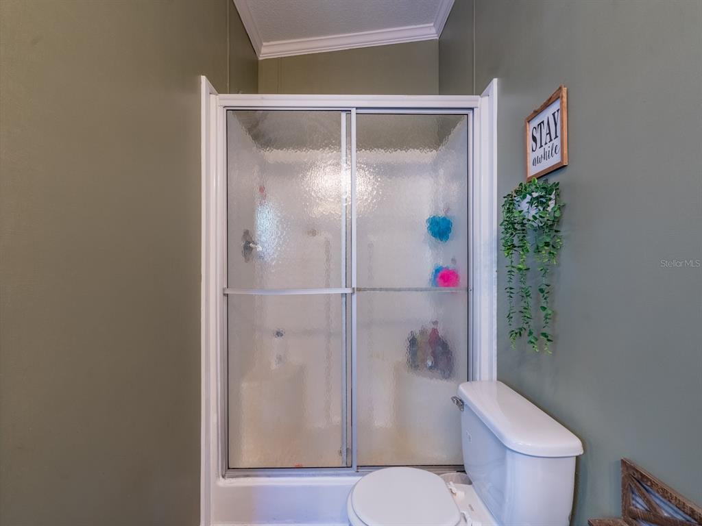 22457 Northeast 130th Court Road Fort McCoy, FL 32134 - Photo 26 of 43 a white toilet sitting next to a bathroom sink
