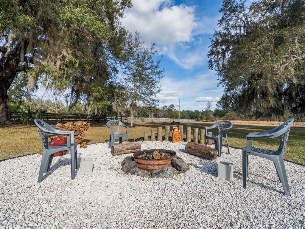 22457 Northeast 130th Court Road Fort McCoy, FL 32134 - Photo 29 of 43 an outdoor sitting area with furniture and lake view