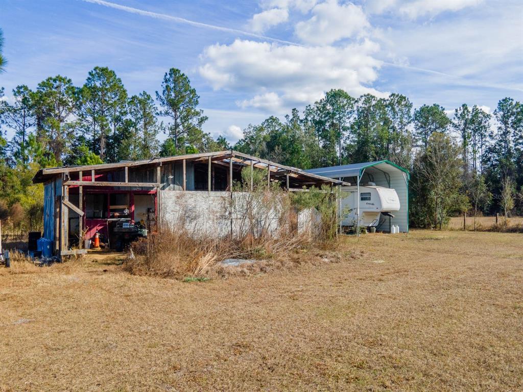 22457 Northeast 130th Court Road Fort McCoy, FL 32134 - Photo 33 of 43 a view of a house with backyard and sitting area