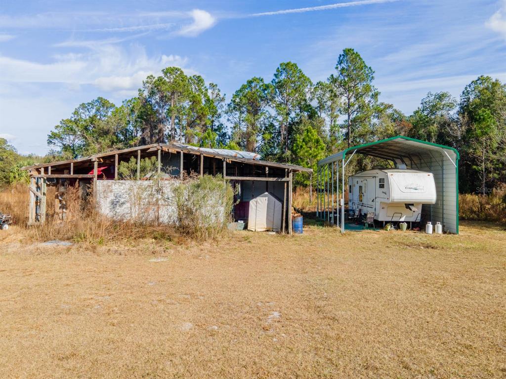 22457 Northeast 130th Court Road Fort McCoy, FL 32134 - Photo 34 of 43 a front view of a house with a yard and garage