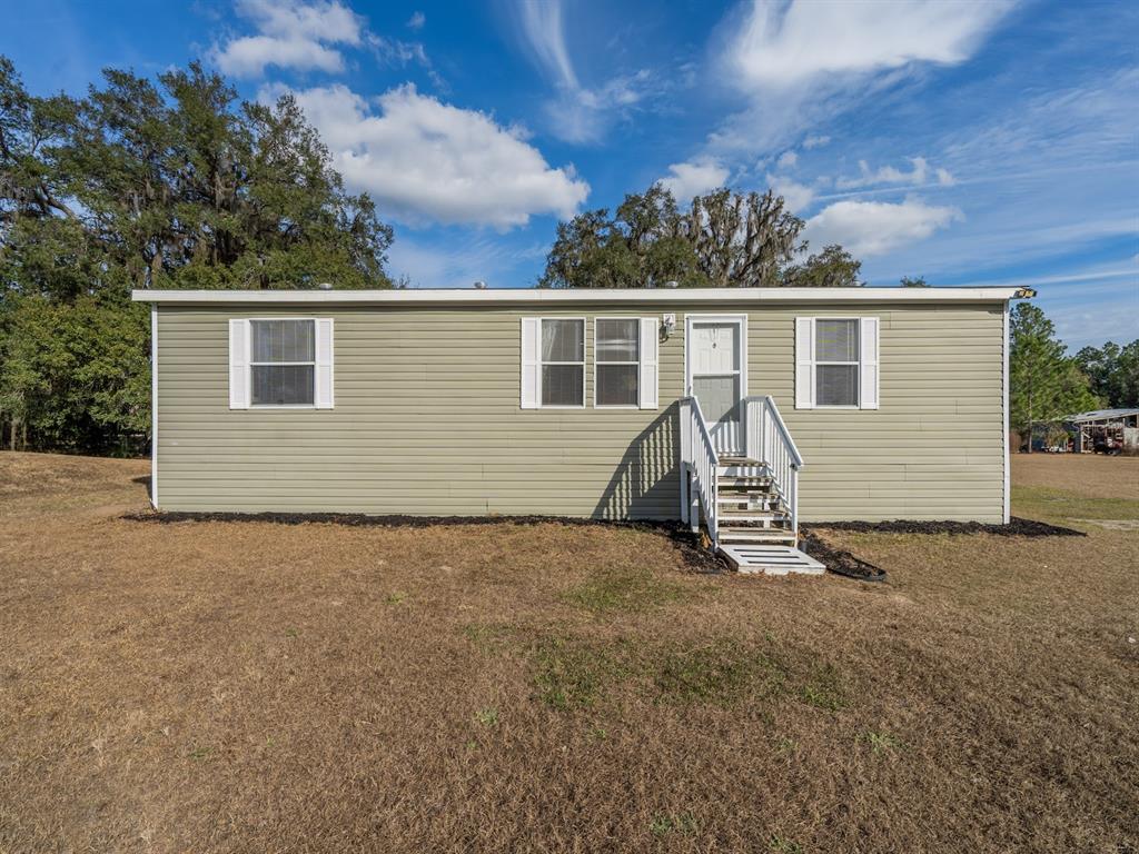 22457 Northeast 130th Court Road Fort McCoy, FL 32134 - Photo 6 of 43 a view of a house with yard