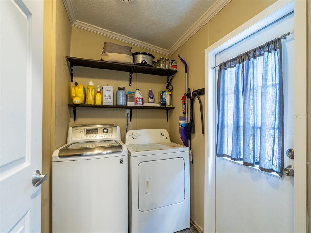 22457 Northeast 130th Court Road Fort McCoy, FL 32134 - Photo 8 of 43 a utility room with dryer and washer