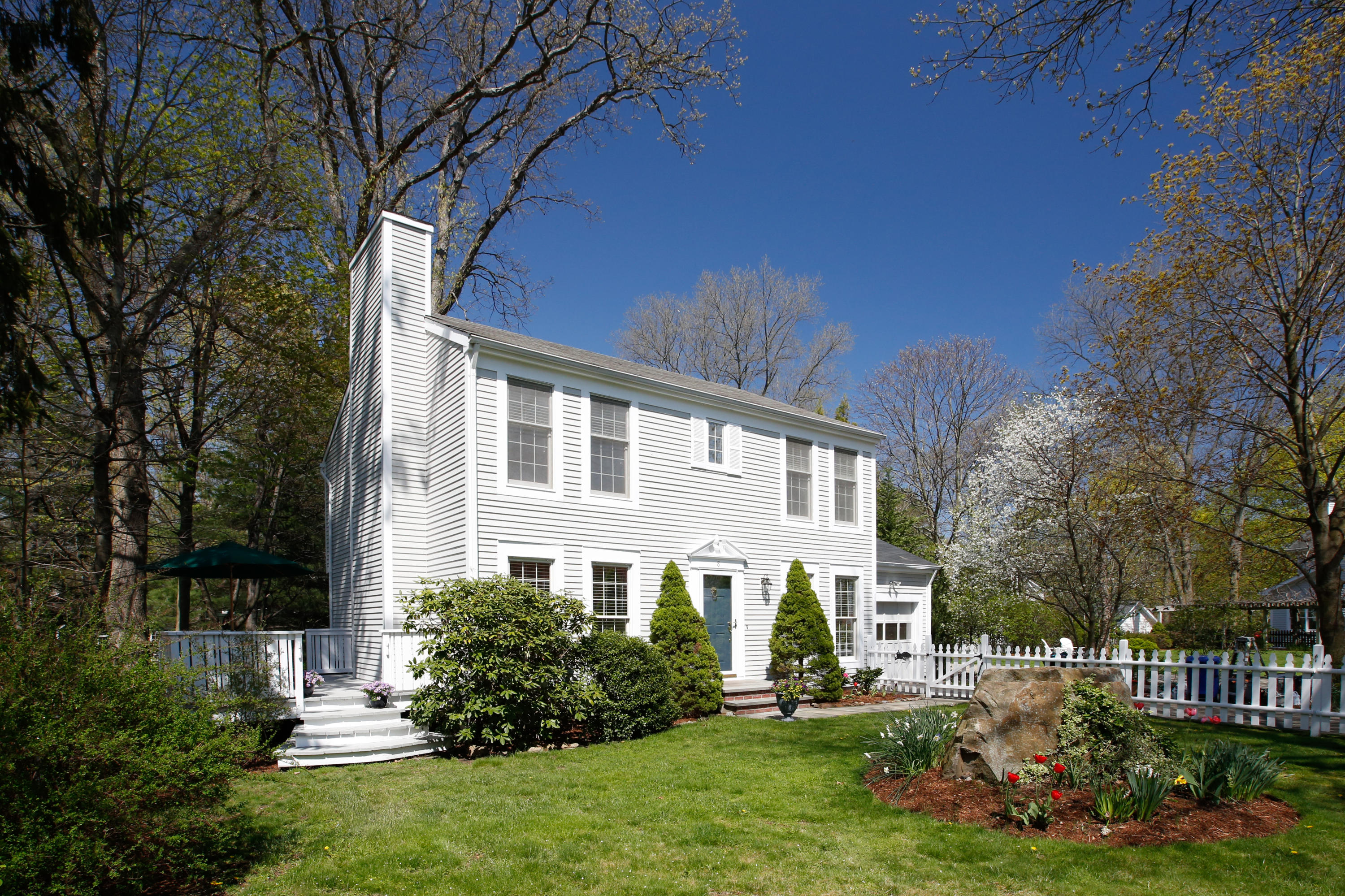 8 Pond Ridge Lane Norwalk, CT 06853 - Photo 1 of 17 a front view of a house with a yard and a garden