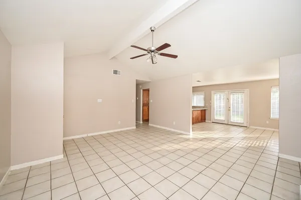 a view of a livingroom with a ceiling fan and window