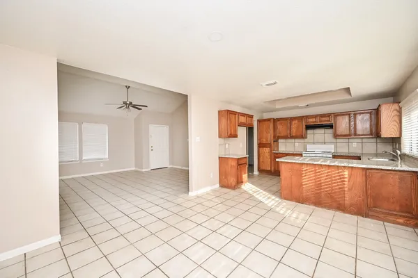 a large white kitchen with cabinets