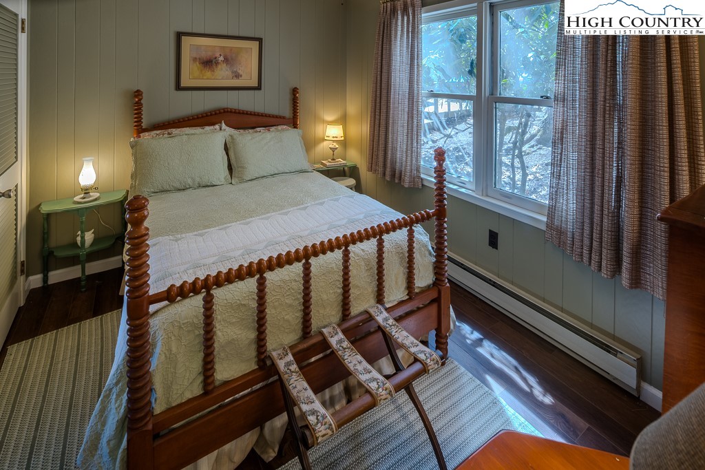 808 Pine Ridge Road Beech Mountain, NC 28604 - Photo 23 of 33 a bed sitting in a bedroom next to a window