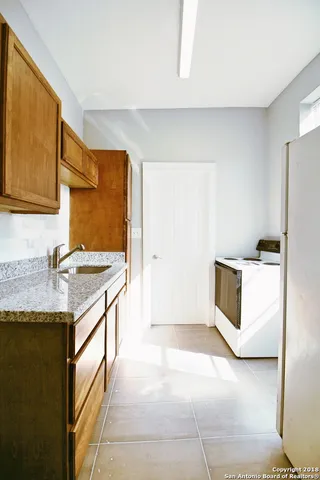 a kitchen with a sink stove and refrigerator