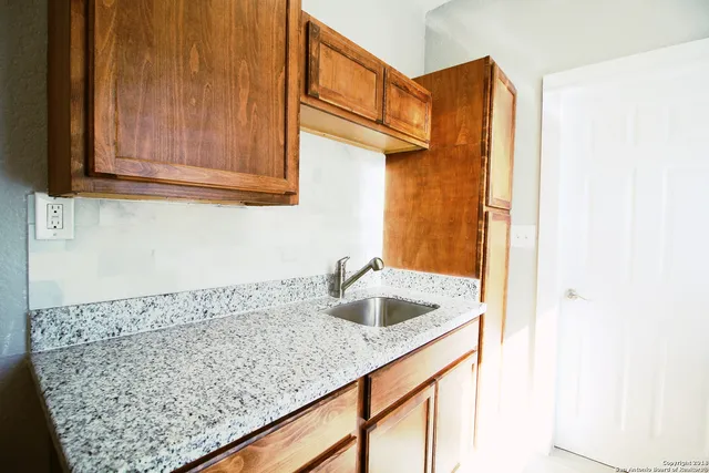 a kitchen with a sink and cabinets