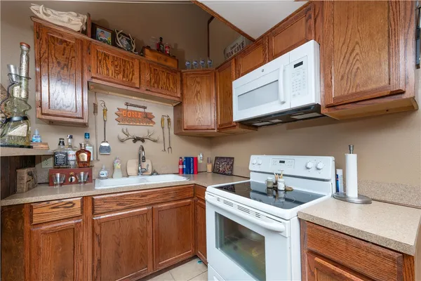 a kitchen with stainless steel appliances granite countertop a sink a stove and cabinets