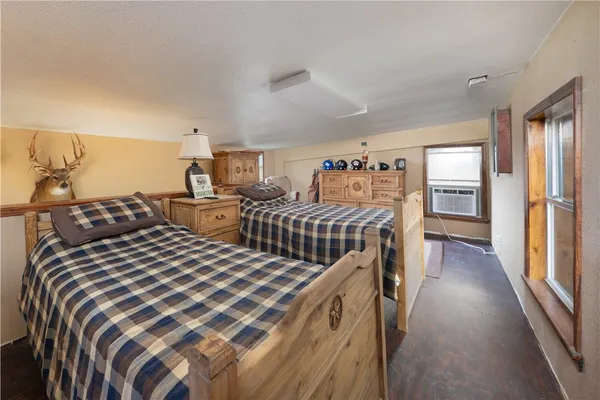 a bedroom with two beds and a window