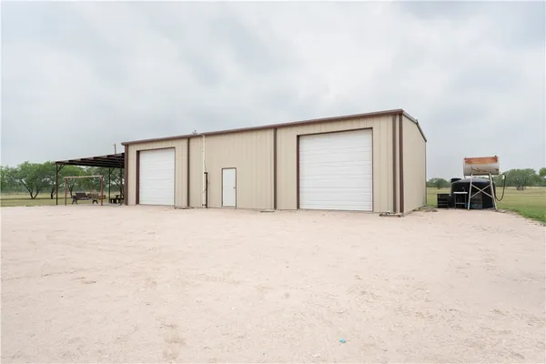 a view of a house with a yard and garage