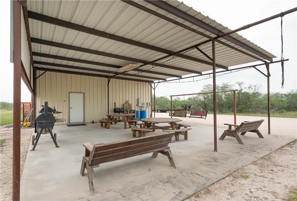 a building outdoor space with patio furniture and a umbrella