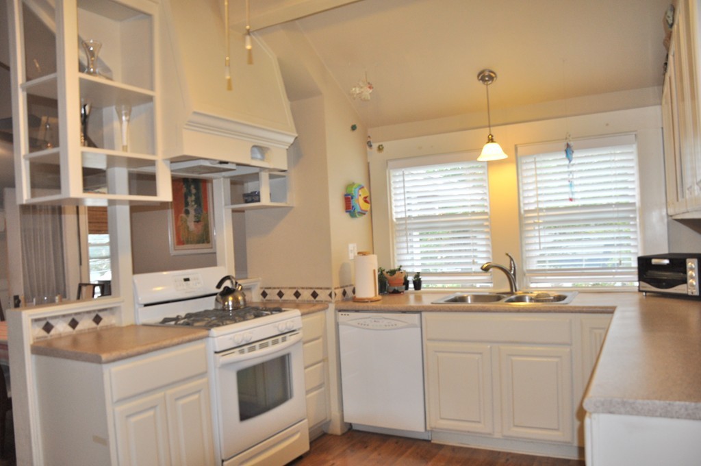 86 Spring Street, Unit B Stoneham, MA 02180 - Photo 4 of 17 a kitchen that has a sink stove and cabinets