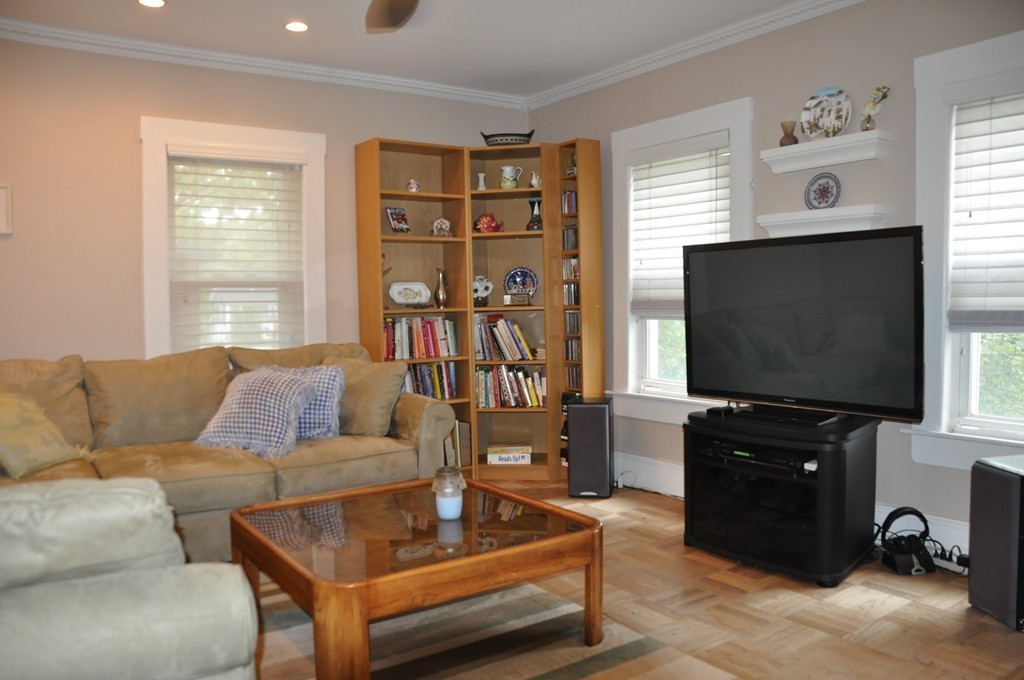 86 Spring Street, Unit B Stoneham, MA 02180 - Photo 7 of 17 a living room with furniture and a flat screen tv