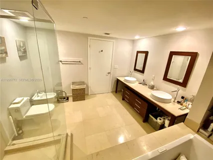 a spacious bathroom with a double vanity sink and a mirror