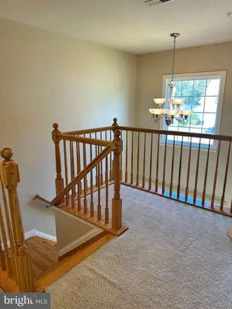 an empty room with windows and chandelier