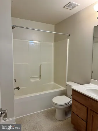 a view of a hallway with a ceiling fan