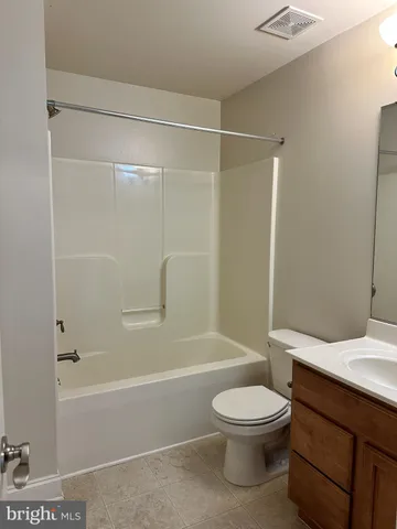 a view of a hallway with a ceiling fan
