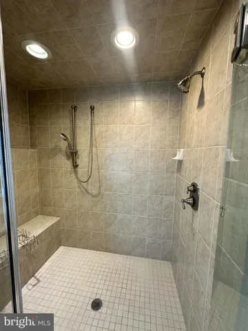 a bathroom with a tub a sink and a large window