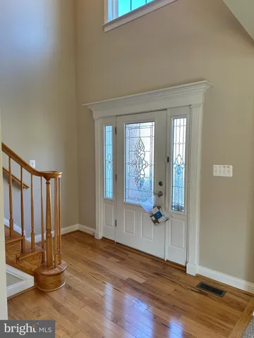 an empty room with wooden floor and a window
