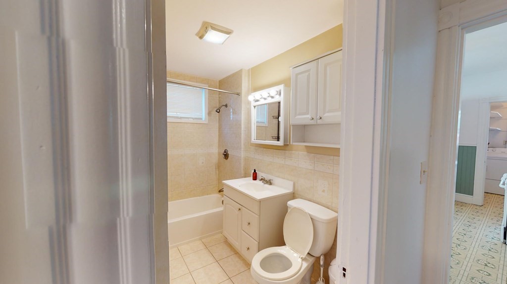 30 Roseclair Street, Unit 2 Boston, MA 02125 - Photo 12 of 14 a bathroom with a toilet sink and mirror
