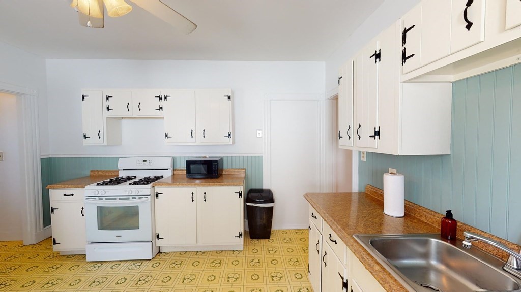30 Roseclair Street, Unit 2 Boston, MA 02125 - Photo 2 of 14 a kitchen with granite countertop a sink a stove and dishwasher