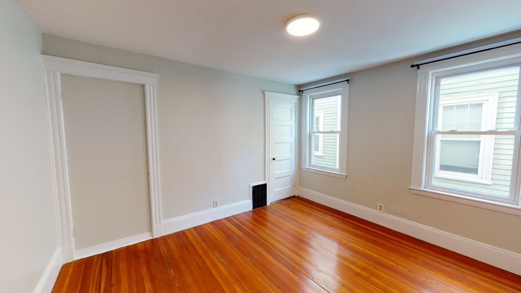 30 Roseclair Street, Unit 2 Boston, MA 02125 - Photo 7 of 14 a bedroom with a bed and wooden floor