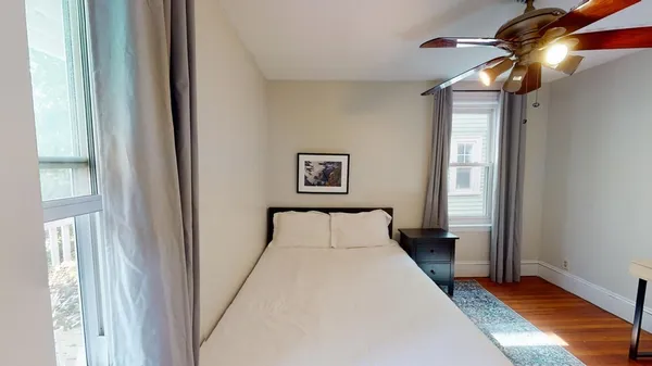 a bedroom with a bed and a window