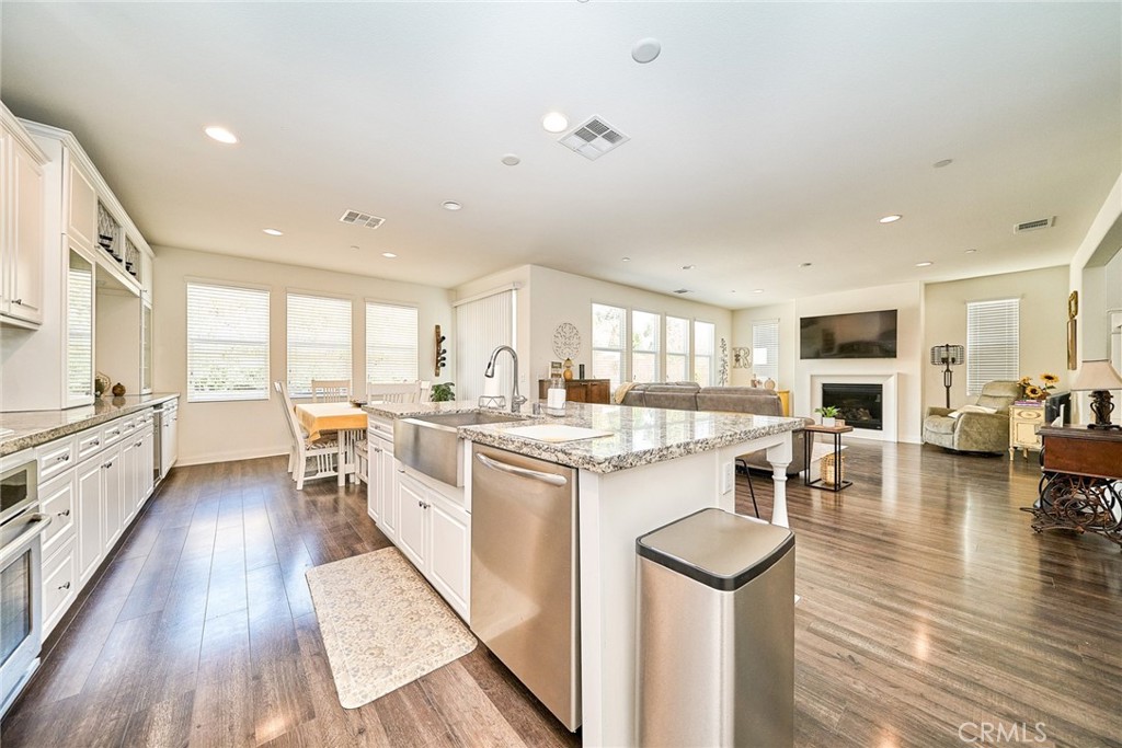 11568 Lark Drive Rancho Cucamonga, CA 91701 - Photo 12 of 20 a open kitchen with sink cabinets and wooden floor