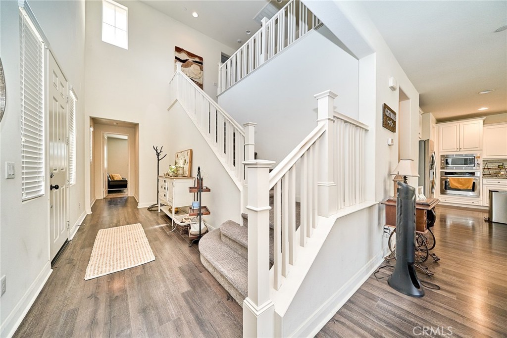 11568 Lark Drive Rancho Cucamonga, CA 91701 - Photo 13 of 20 a view of staircase with lots of frames on wall and a dining table