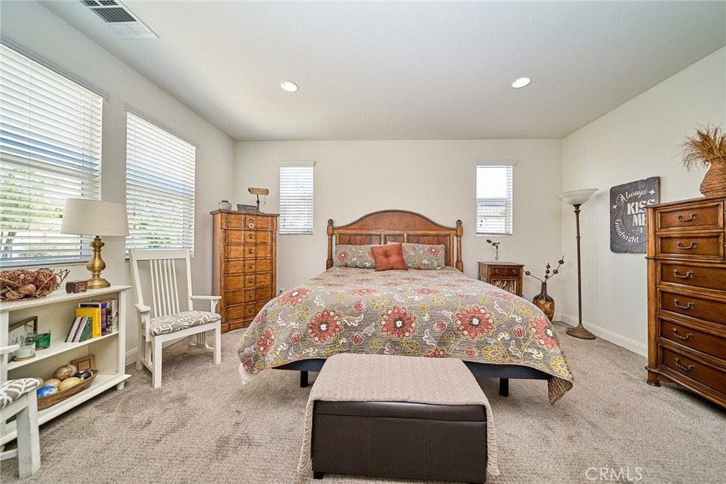 11568 Lark Drive Rancho Cucamonga, CA 91701 - Photo 16 of 20 a bedroom with a bed and a book shelf