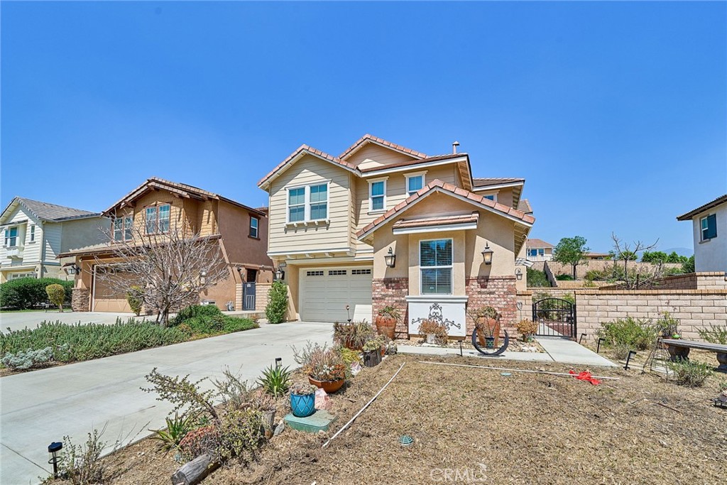 11568 Lark Drive Rancho Cucamonga, CA 91701 - Photo 2 of 20 a front view of a house with a yard