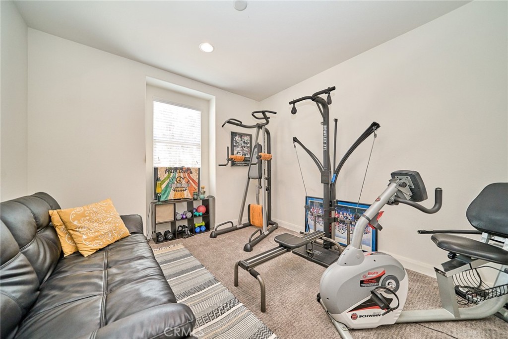 11568 Lark Drive Rancho Cucamonga, CA 91701 - Photo 6 of 20 a room with gym equipment and view of living room