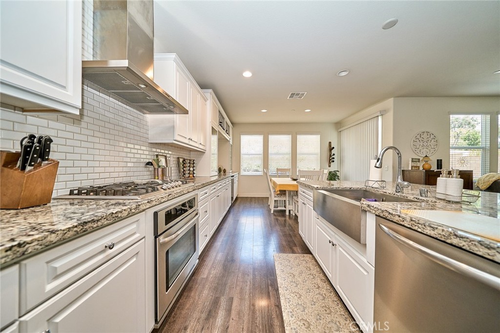 11568 Lark Drive Rancho Cucamonga, CA 91701 - Photo 10 of 20 a kitchen with stainless steel appliances granite countertop a stove and a sink