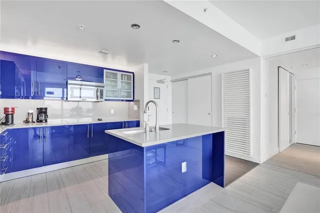 a kitchen with stainless steel appliances granite countertop a sink dishwasher stove and wooden cabinets