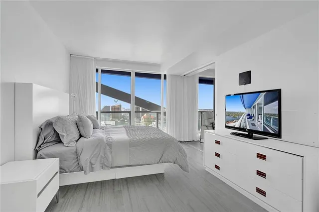 a bedroom with a bed and a view of kitchen
