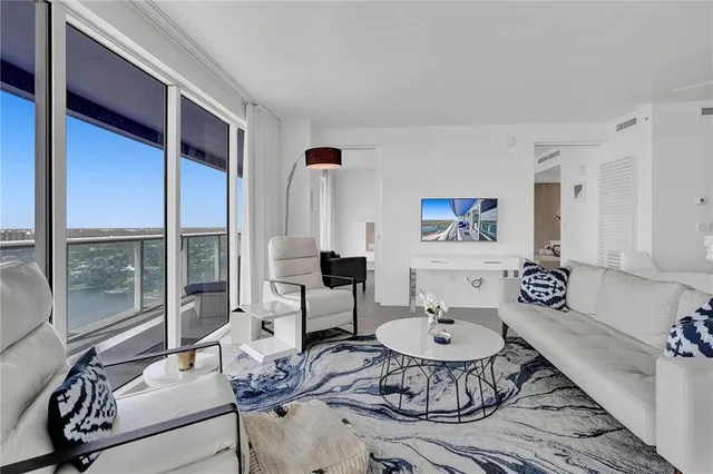 a balcony with wooden floor stairs and potted plants