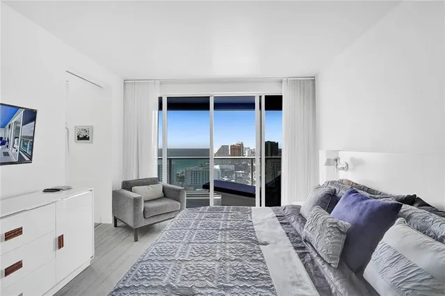 a living room with furniture and a baby crib