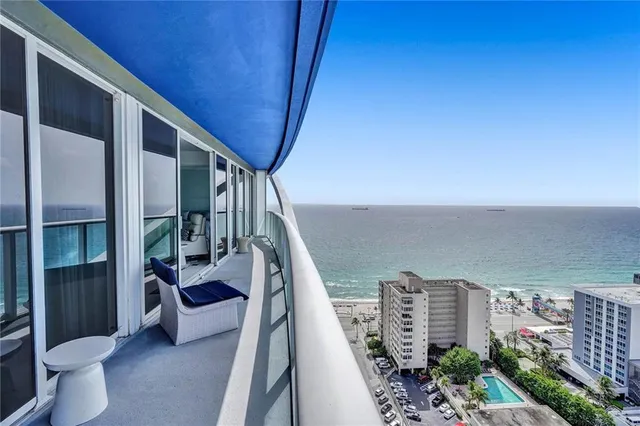 a kitchen with kitchen island a large counter top a sink a stove and cabinets