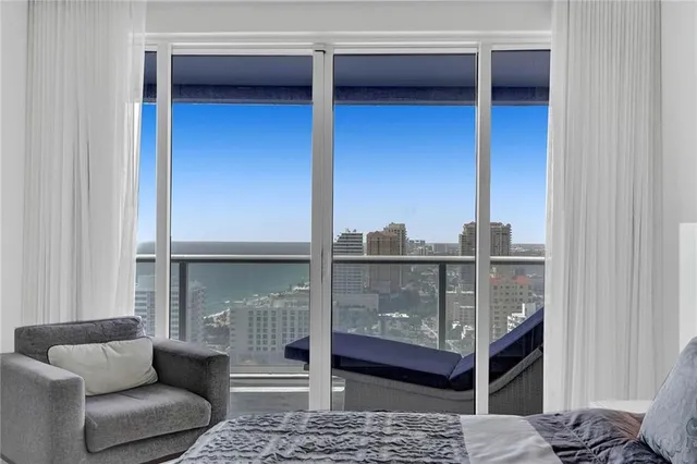 a bedroom with two beds and a large window