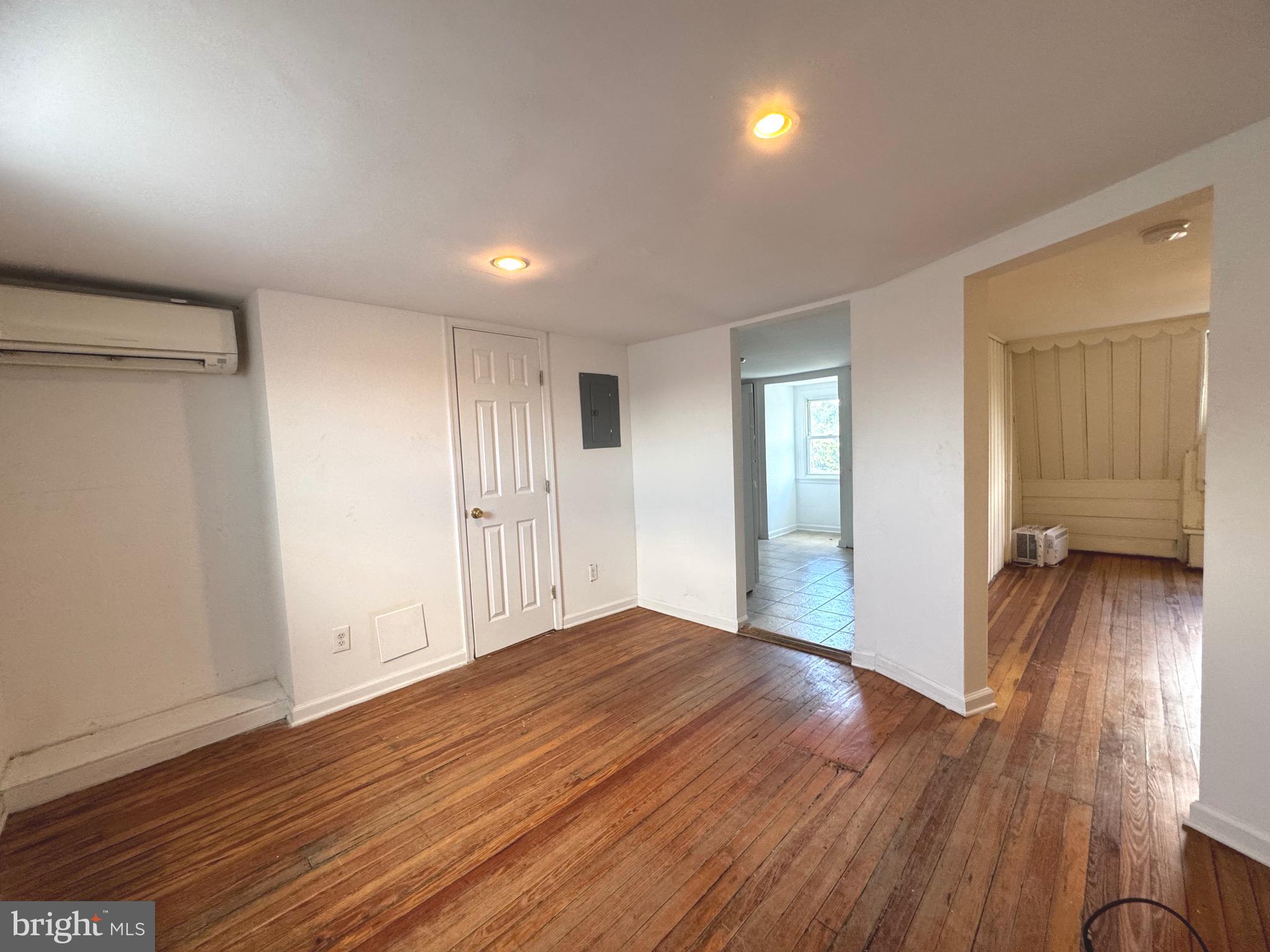 805 Brooks Lane, Unit 3 Baltimore, MD 21217 - Photo 2 of 9 wooden floor in an empty room with a window