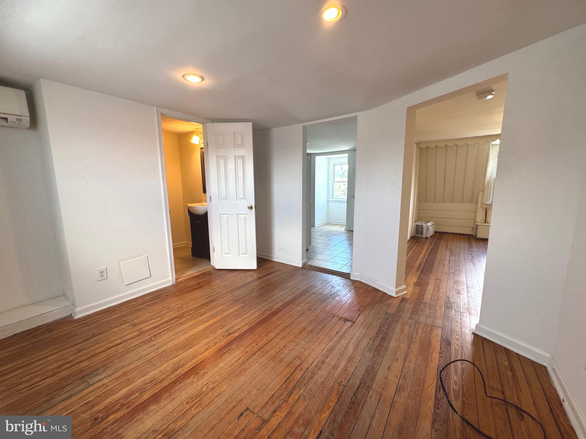 805 Brooks Lane, Unit 3 Baltimore, MD 21217 - Photo 3 of 9 an empty room with wooden floor and closet