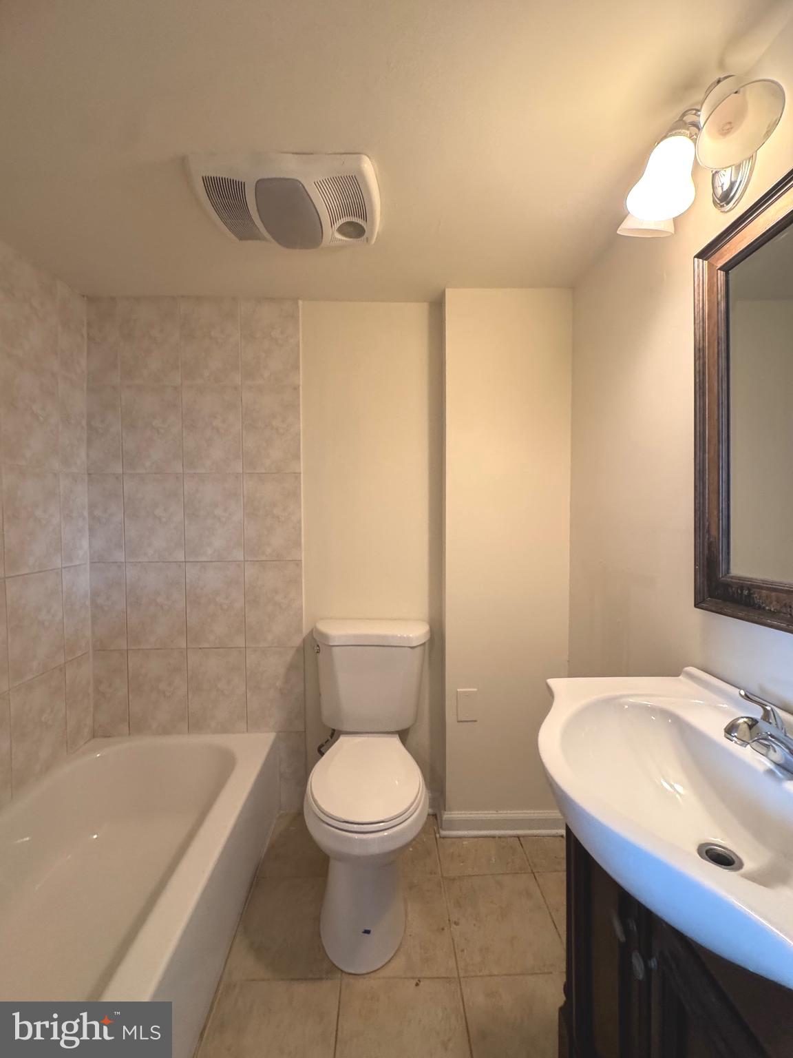 805 Brooks Lane, Unit 3 Baltimore, MD 21217 - Photo 4 of 9 a bathroom with a sink a toilet and shower