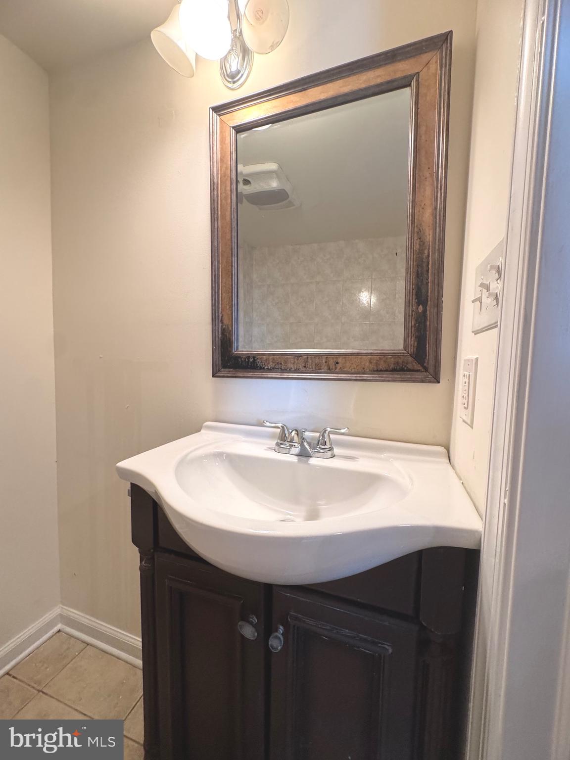 805 Brooks Lane, Unit 3 Baltimore, MD 21217 - Photo 5 of 9 a bathroom with a sink vanity and a mirror