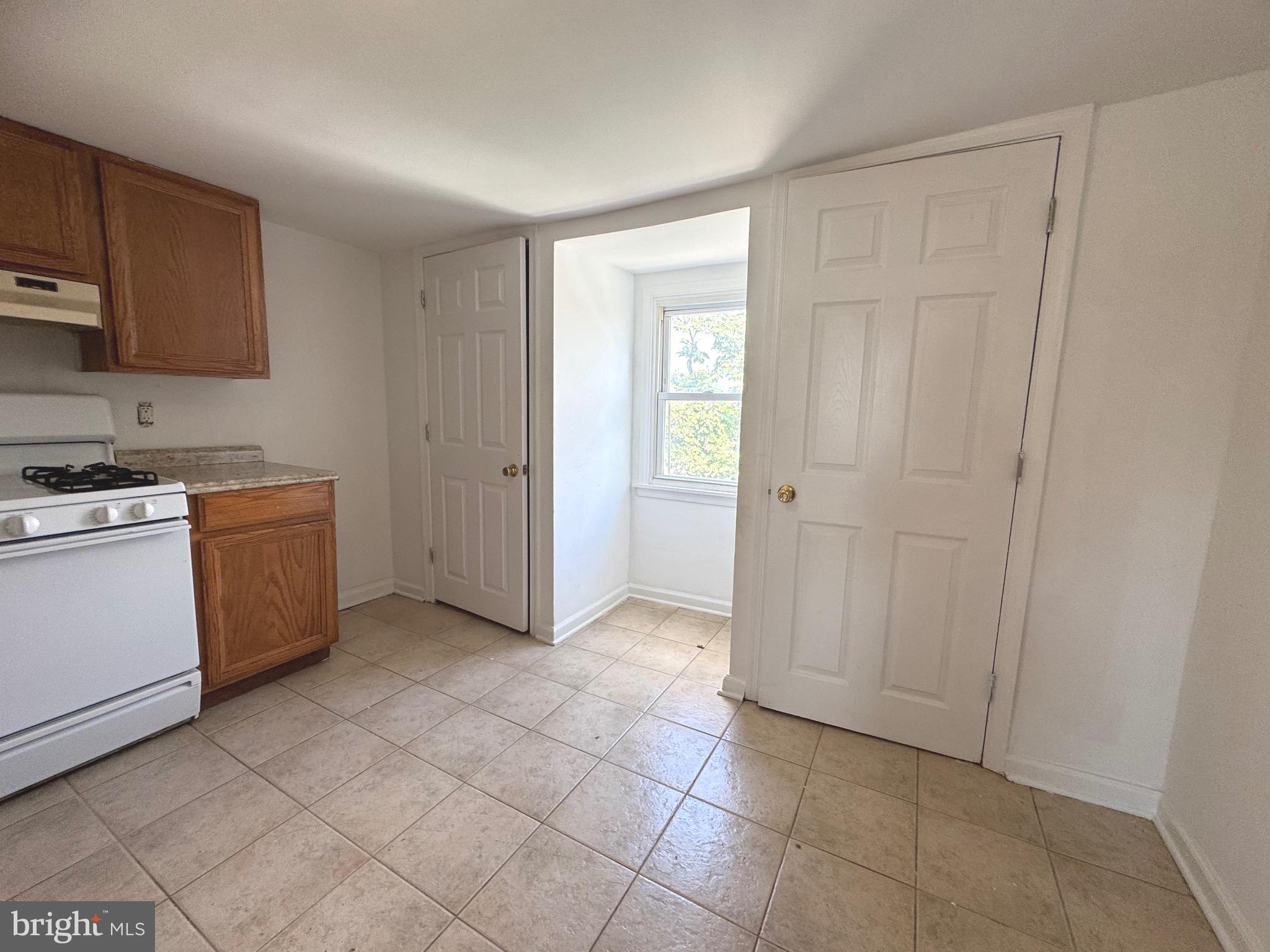 805 Brooks Lane, Unit 3 Baltimore, MD 21217 - Photo 6 of 9 a view of a kitchen with a sink cabinets and a window
