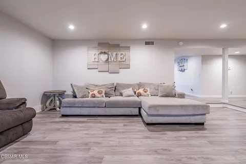 a view of a dining room with furniture a rug and wooden floor